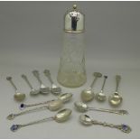 Twelve silver and white metal spoons including two Rolex spoons and a silver topped glass shaker