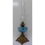 An oil lamp with blue glass reservoir