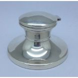 A silver capstan inkwell,