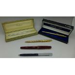 Five pens including two Parker gold plated ballpoint pens