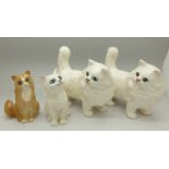 Three Beswick kittens and a Royal Doulton ginger cat