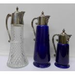 Two Wade Falstaff claret jugs with plated tops and one other claret jug,