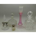 Four scent bottles including one with silver top and a glass candlestick