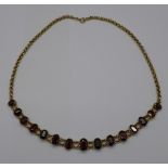 A 9ct gold and garnet necklet, 14.