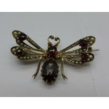 A garnet and pearl set insect brooch,