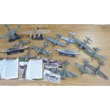 A collection of model military aircraft and two ships