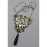 A large Art Nouveau style white metal pendant and chain