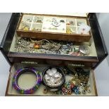 A jewellery box containing jewellery including Norwegian silver and enamel brooch and a Cartier