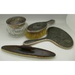 A three piece silver and tortoiseshell dressing table set and a buffer