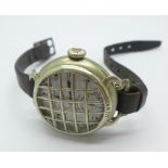 A WWI trench watch with guard and strap, the dial marked Metro Watch,
