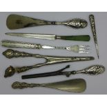 Two silver handled shoe horns, etc.