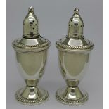 A pair of Duchin weighted silver pepperettes, gross weight 294.