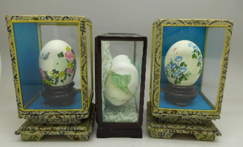 Four Chinese decorated eggs in three display cases - Image 2 of 2