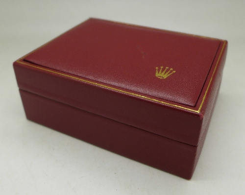 A red Rolex wristwatch box