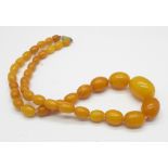 A amber bead necklace, 22.
