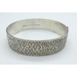 A 1970's bark effect silver bangle