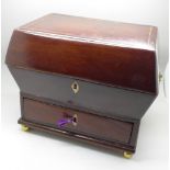 A mahogany sarcophagus shaped jewellery box