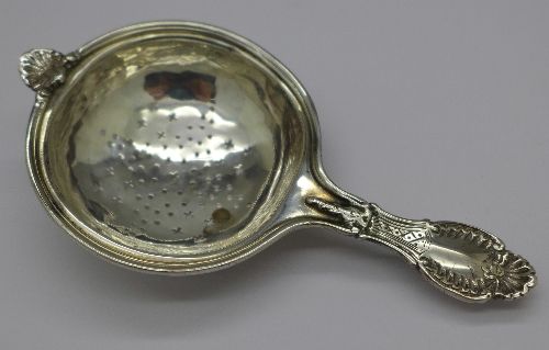 A white metal tea strainer