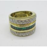 A yellow metal set, emerald and diamond ring, approximately 1 carat diamond weight, 15.