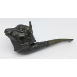 A carved wooden pipe in the form of a bull,