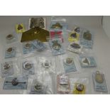 A collection of sweetheart brooches, cap badges, a silver shooting fob medal,