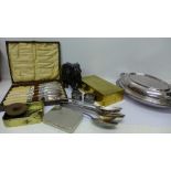 A plated tureen, six plated serving spoons, cased fish knives and forks, two plated napkin rings,