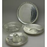 A pierced silver dish, a silver dish in the form of a sombrero, a white metal dish and a card tray,