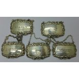 A set of five silver 'wine' labels