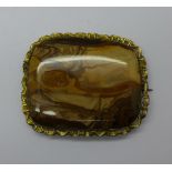 A large gilt metal and agate brooch,