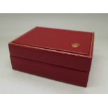 A red Rolex wristwatch box