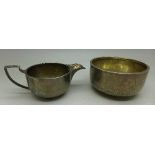 A silver cream jug and sugar bowl, Birmingham 1923, 129.