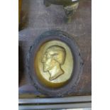 A continental gilt oval plaster plaque, bust of a gentleman, indistinctly inscribed,