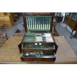 A 1920's oak cased canteen of plated cutlery with ivory handles