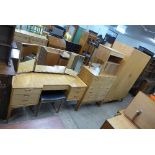 A teak bedroom suite, comprising a wardrobe, dressing table, chest of drawers,