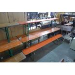 A German folding trestle table and a pair of benches