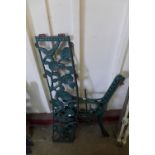 A pair of cast iron bench ends and a back plate