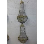 A pair of gilt metal and crystal glass wall lights