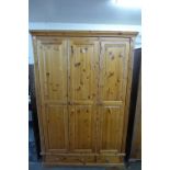 A pine three door wardrobe