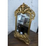 An Art Nouveau style gilt framed mirror