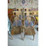 A set of four oak dining chairs and a pair of wheelback chairs