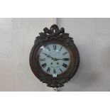 A Black Forest style carved walnut circular wall clock, the dial signed Potter & Desbois,