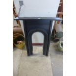 A Victorian cast iron and wood fire surround