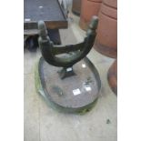 A Victorian cast iron boot scraper on a stone base