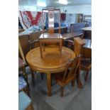 A Chinese cherrywood extending dining table and five chairs