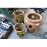 Three terracotta strawberry pots