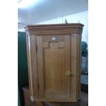 A hanging pine corner cupboard