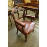 A Victorian mahogany and leather upholstered armchair