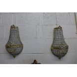 A pair of gilt metal and crystal glass wall lights