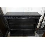 A Victorian Jacobean Revival carved ebonised open bookcase