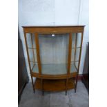 An Edward VII satinwood bow-front display cabinet